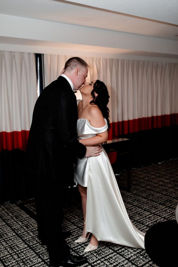Bride and groom kissing during their first look at Paris Hotel in Las Vegas