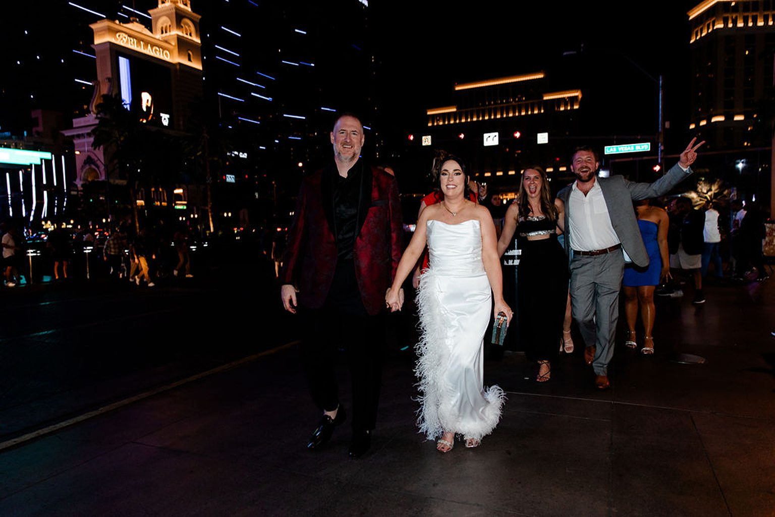 Bride and groom walking downtown with their wedding party