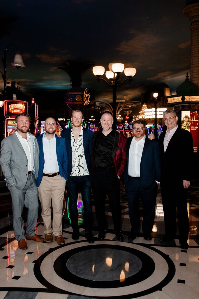 Groom and his groomsmen posing for a photo in a Las Vegas casino