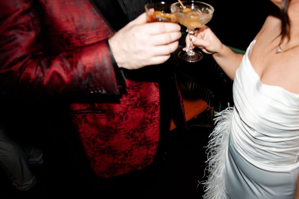 Bride and groom toasting their drinks