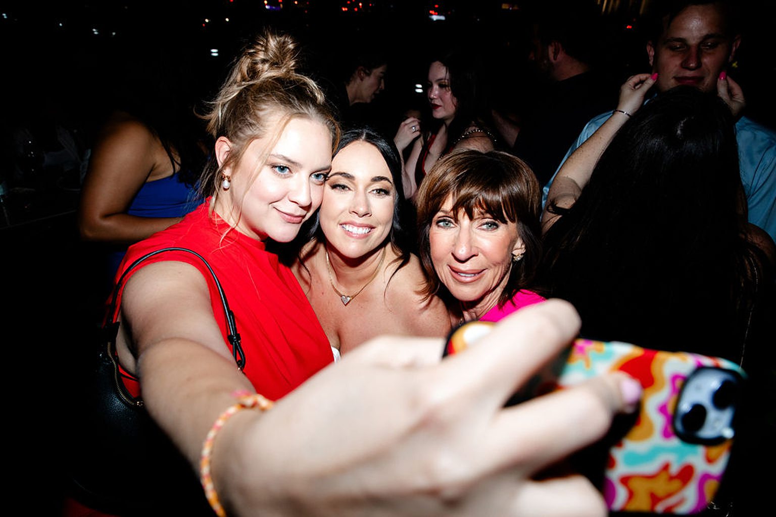Bride taking selfies with guests