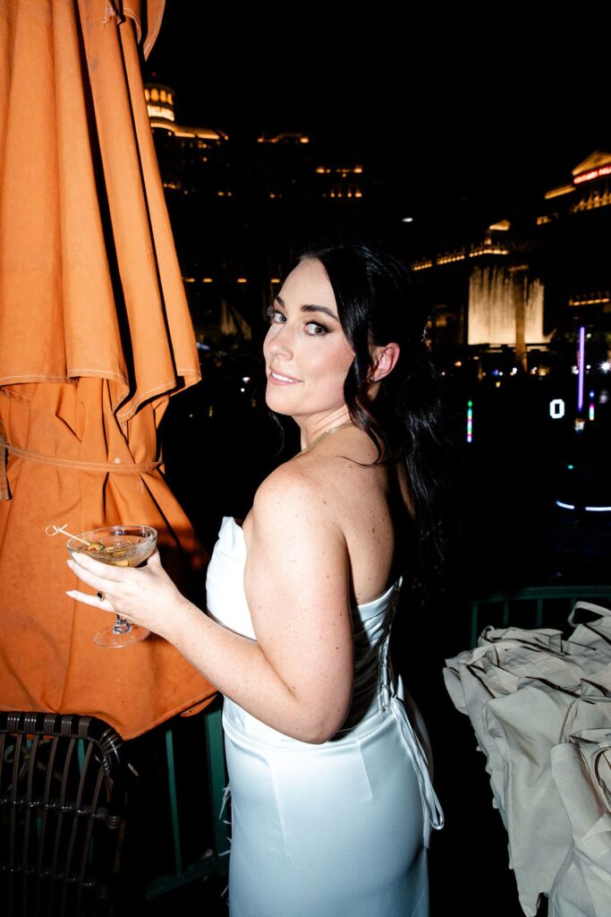 Bride having drinks during her Las Vegas wedding weekend welcome reception