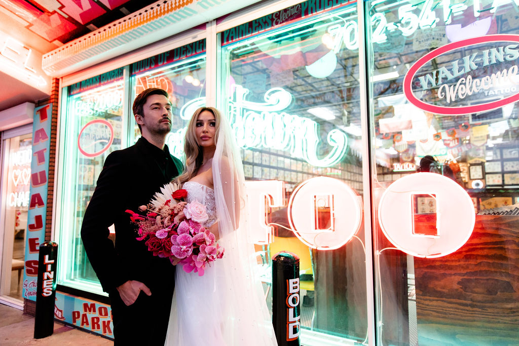 Couple posing in front of Downtown Tattoo in Las Vegas