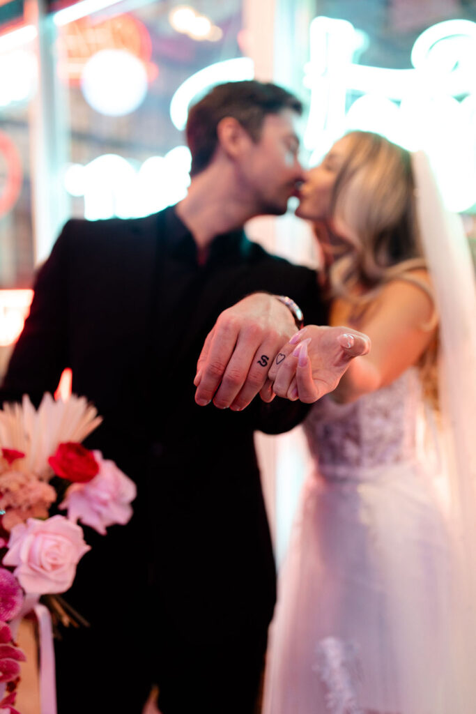 Couple showing off their tattoos during their downtown vintage Las Vegas wedding photos