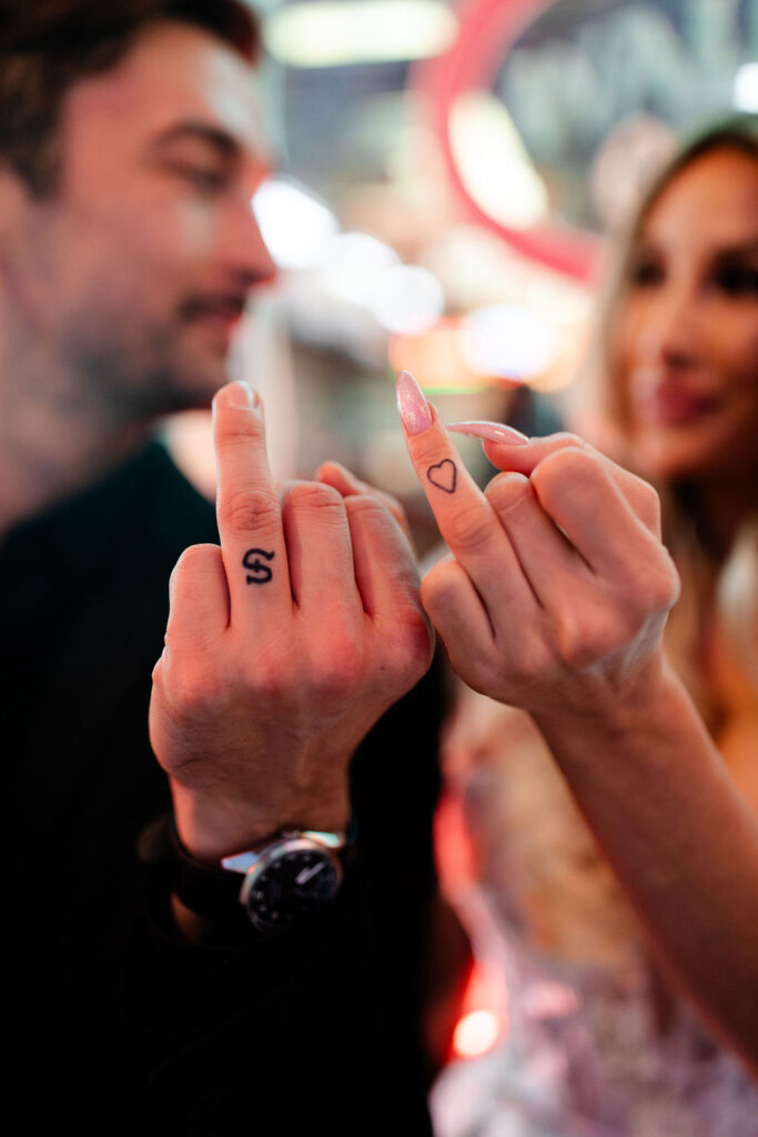 Couple showing off their tattoos during their downtown vintage Las Vegas wedding photos
