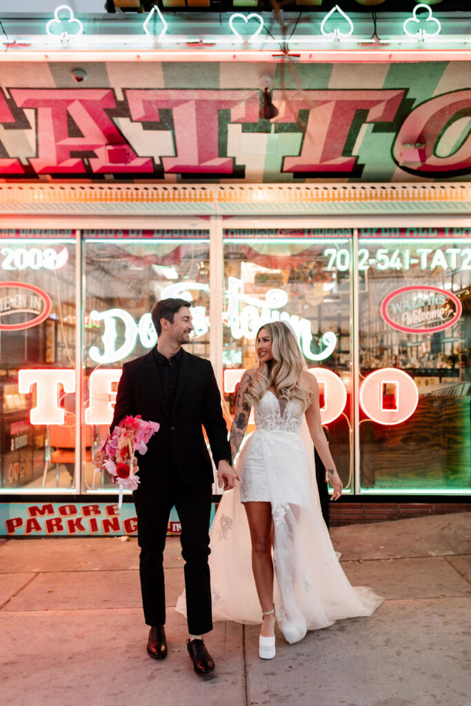 Couple posing in front of Downtown Tattoo on Fremont Street