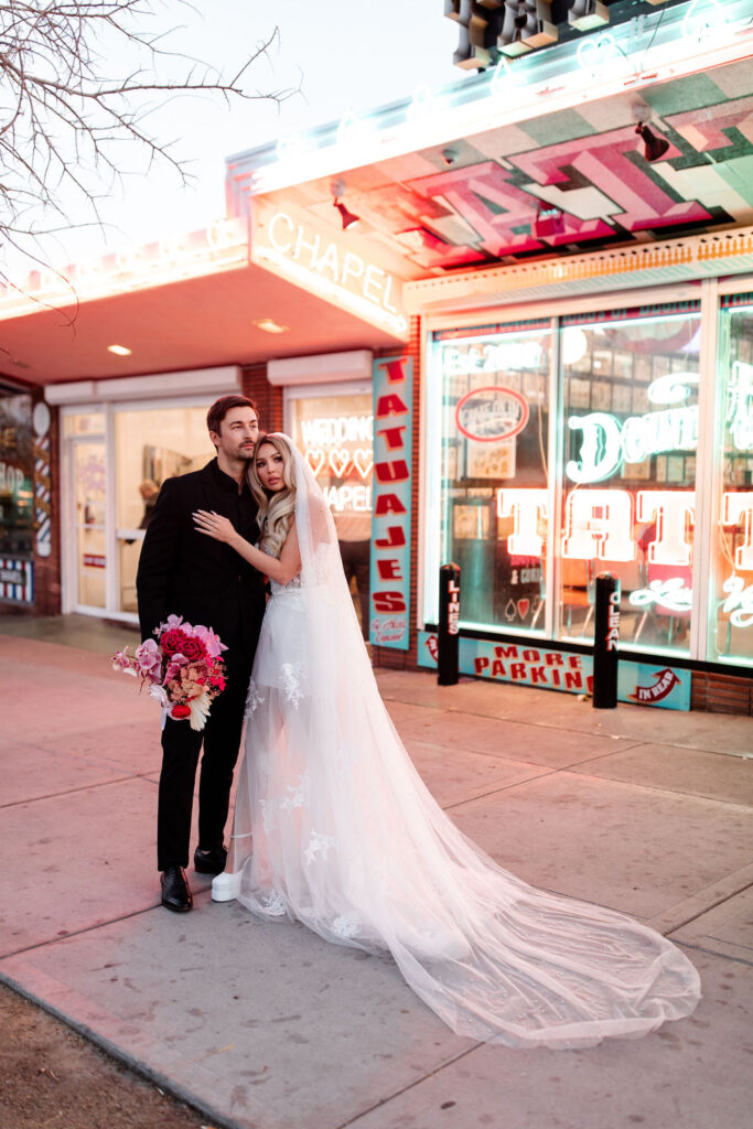 Couples editorial wedding photos in front of Downtown Tattoo on Fremont Street