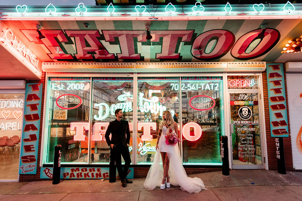 Couples editorial wedding photos in front of Downtown Tattoo on Fremont Street