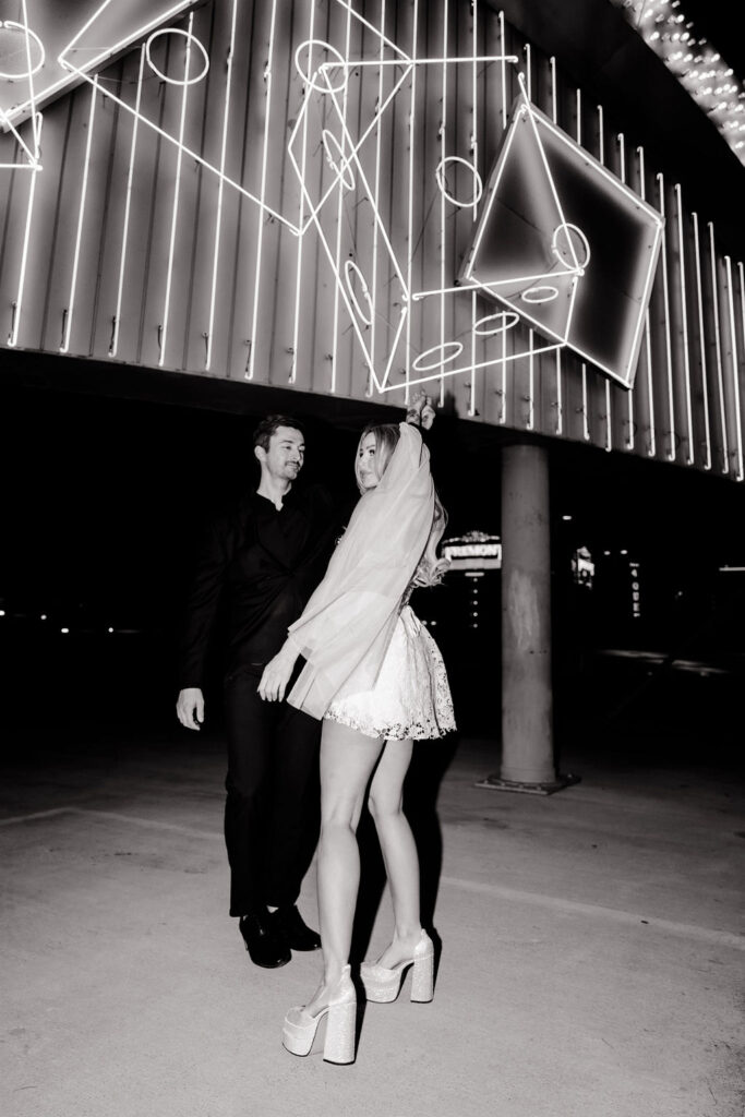 Black and white photo of a bride and groom posing on Binion's Rooftop in Las Vegas