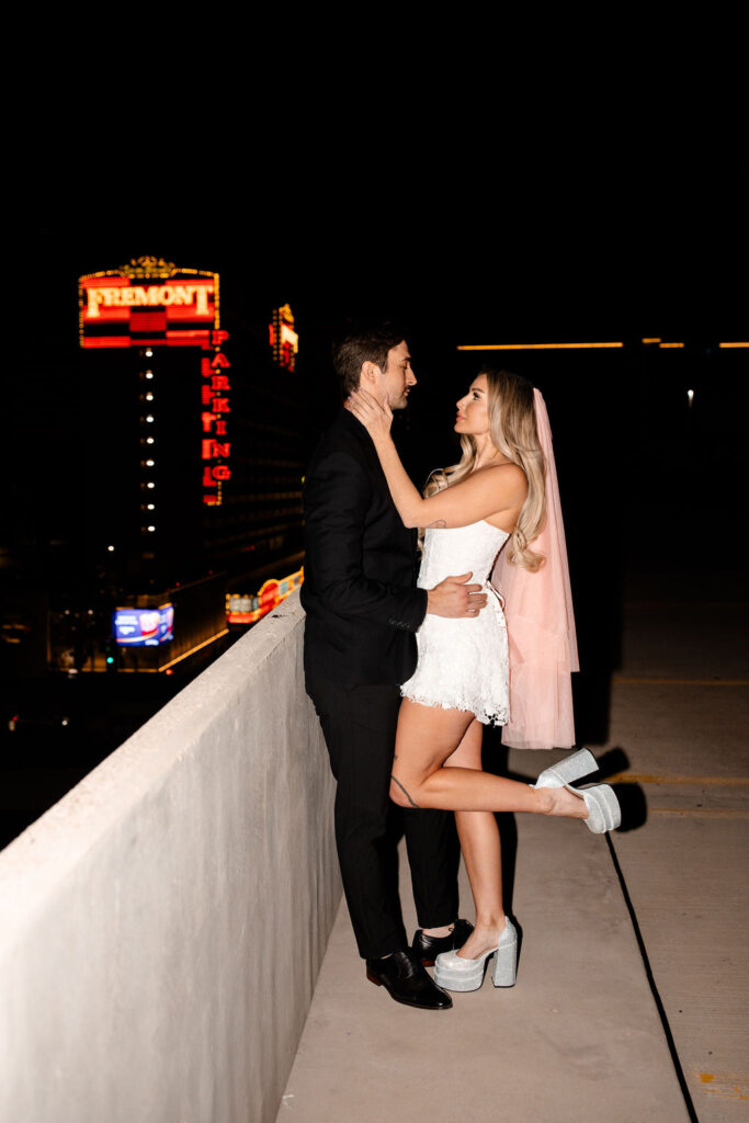 Couple posing on a rooftop at night in Las Vegas