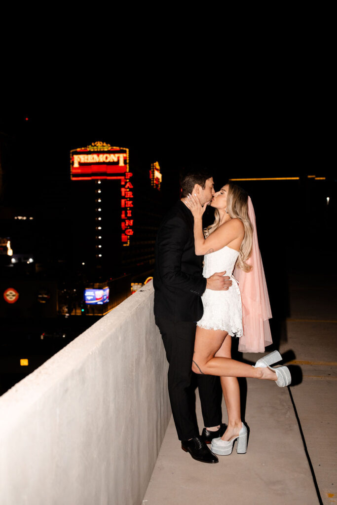 Couple kissing on a rooftop at night in Las Vegas