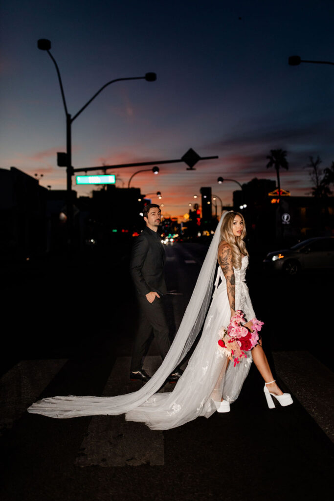 Couple walking across the street for their night vintage Las Vegas wedding photos