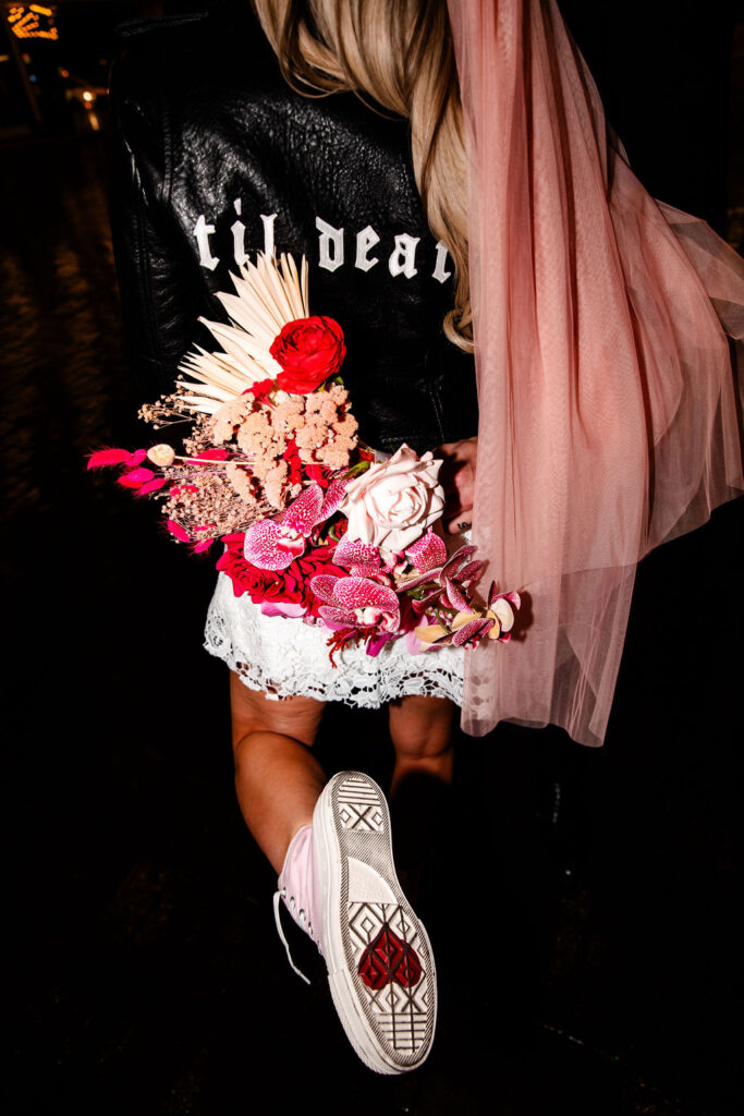 Las Vegas bridal style wearing leather "till death" jacket with pink high-tops