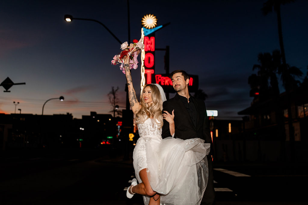 Couple posing in front of Fergusons in downtown Las Vegas
