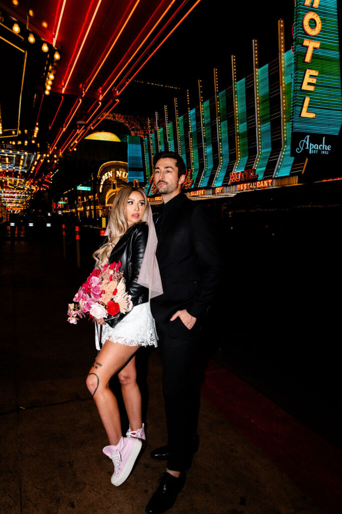 Couple posing for their Las Vegas wedding photos on Fremont Street