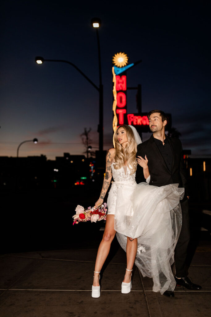 Couple posing in front of Fergusons at night