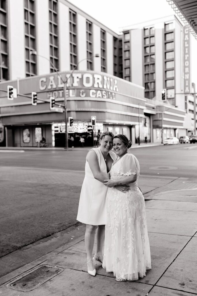 Black and white elopement photo of a couple posing downtown