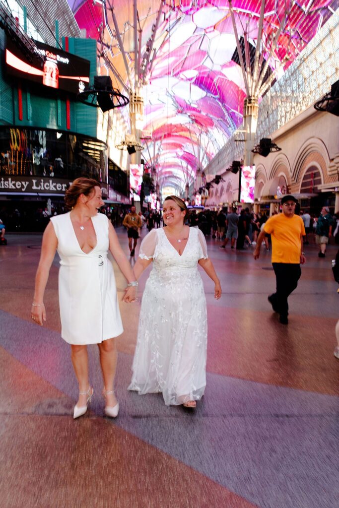 Couple holding hands and walking in downtown Las Vegas
