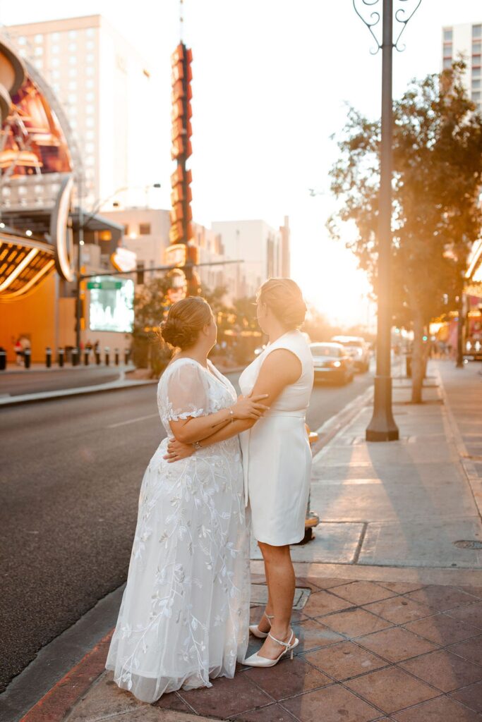 Couple posing for their downtown Las Vegas wedding photos at sunset