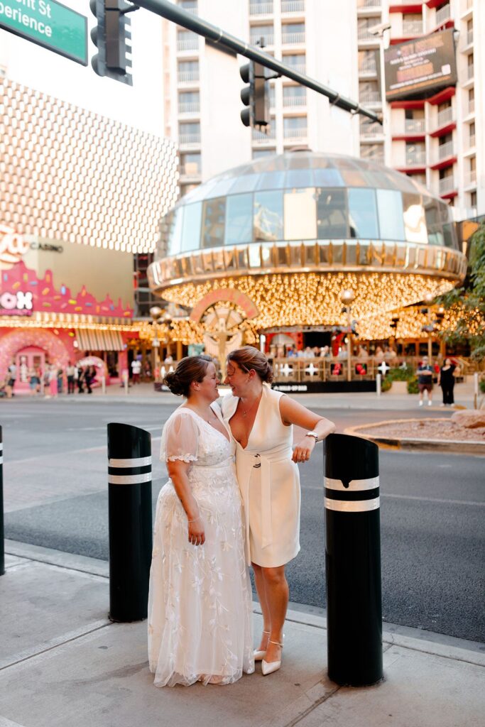 Couple posing on Fremont Street for their Las Vegas wedding photos