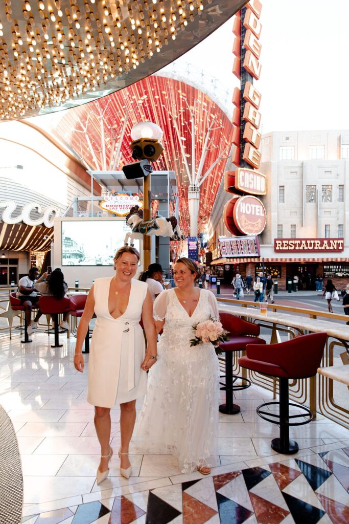 Couple walking at Carousel Bar for their downtown Las Vegas wedding photos