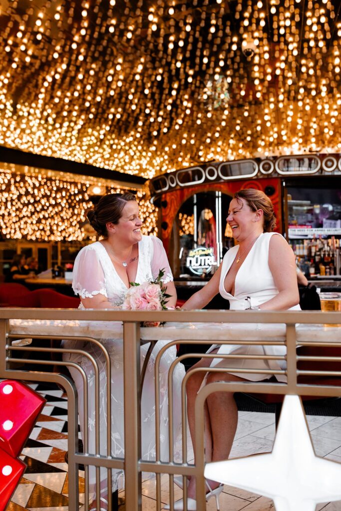 Couple laughing together during their downtown Las Vegas wedding photos at Carousel Bar