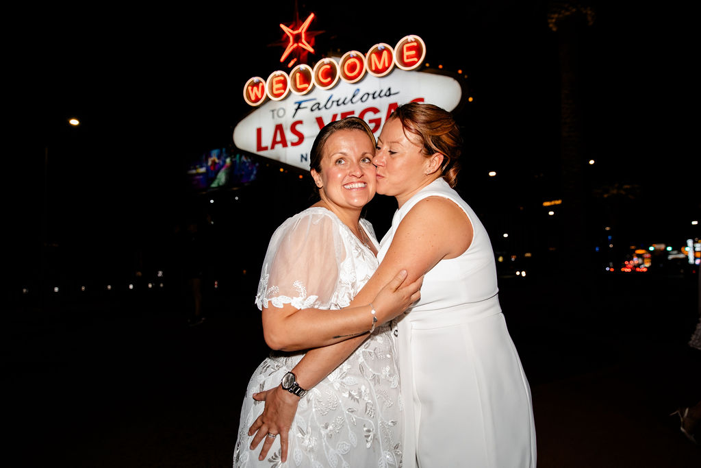 LQBTQ+ Las Vegas wedding photos in front of the Welcome to Fabulous Las Vegas sign