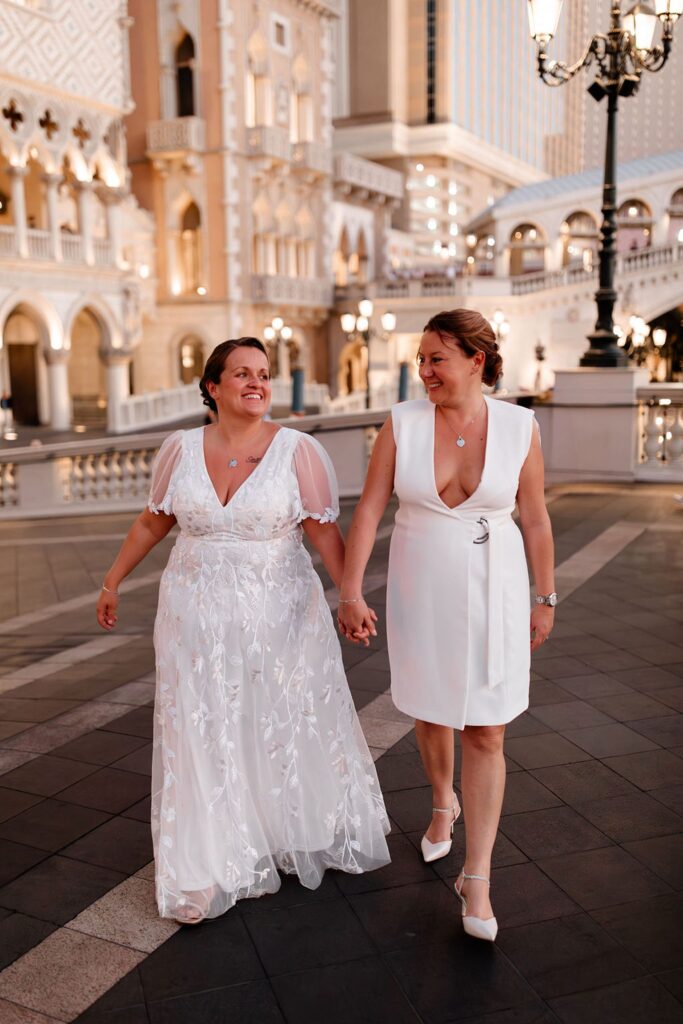 Couple walking outside the Venetian for their Las Vegas wedding photos