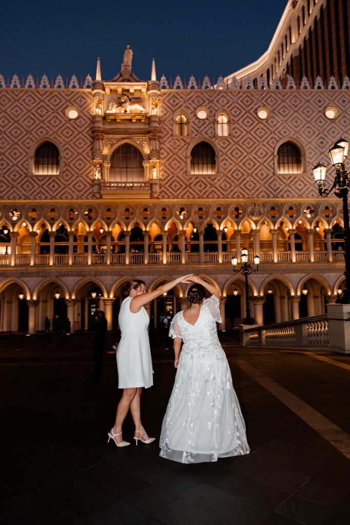 Woman twirling her partner during their Venetian Las Vegas wedding photos