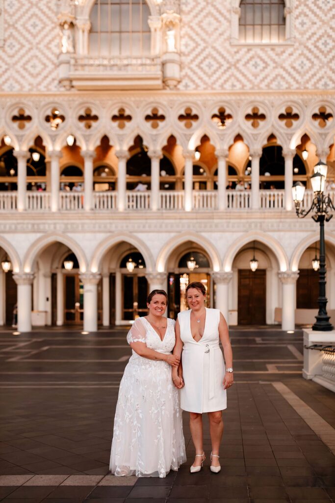 Couple posing in front of the Venetian for their Las Vegas wedding photos