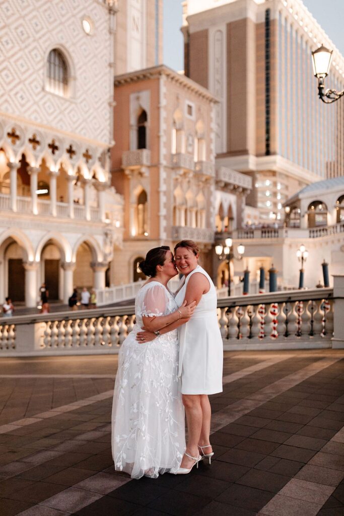 Couple kissing outside the Venetian for their LGBTQ+ Las Vegas wedding photos