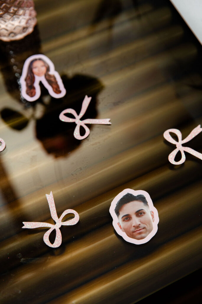 Custom face cutouts and glitter bow confetti for a themed Las Vegas bachelorette party