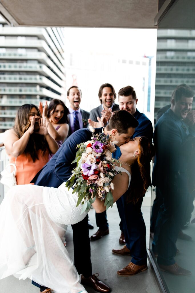 Bride and groom kissing on the balcony of their Cosmopolitan Wraparound Terrace Suite