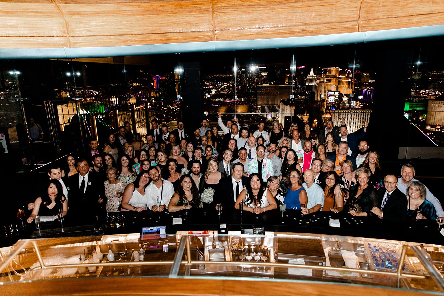 Big wedding group posing for photos at Skyfall Lounge at The W