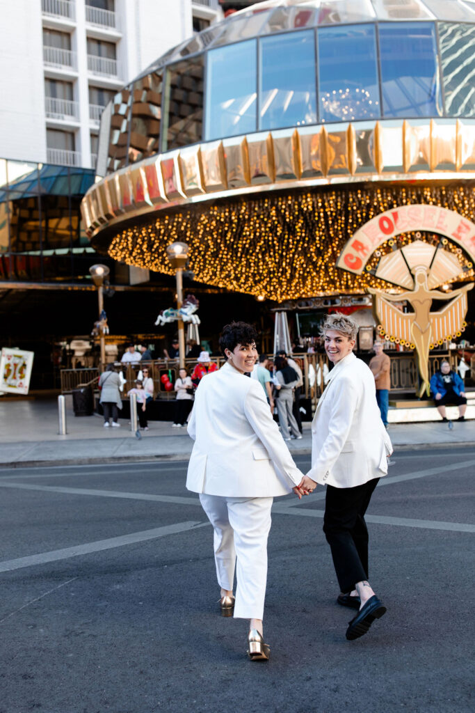 LGBTQ+ couple walking downtown for their Las Vegas wedding photos