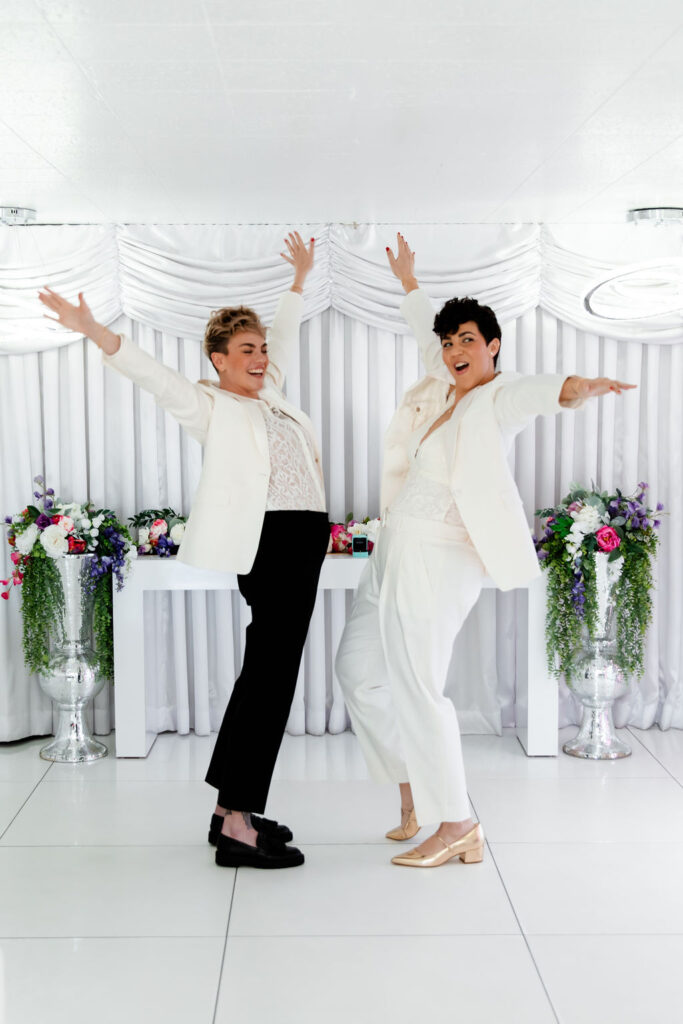 Couple posing for their fun Las Vegas elopement photos at Little White Wedding Chapel