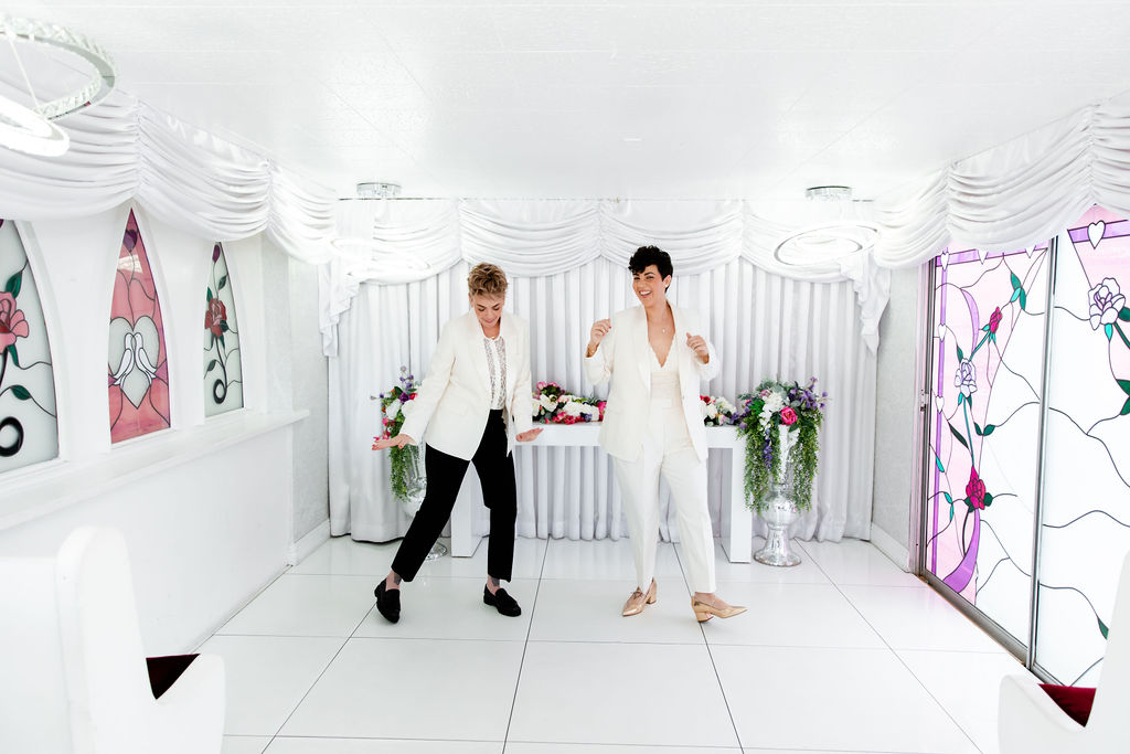 LGBTQ+ couple having fun and dancing after their Little White Wedding Chapel elopement