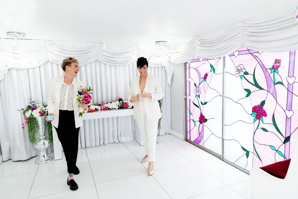 LGBTQ+ couple having fun and dancing after their Little White Wedding Chapel elopement