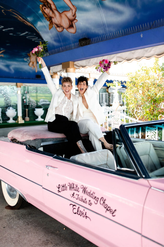 LGBTQ+ couples Pink Cadillac wedding photos at Little White Wedding Chapel