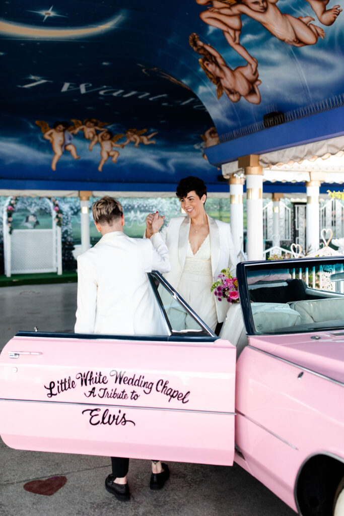 LGBTQ+ couples photos with the pink Cadillac at Little White Wedding Chapel in Las Vegas