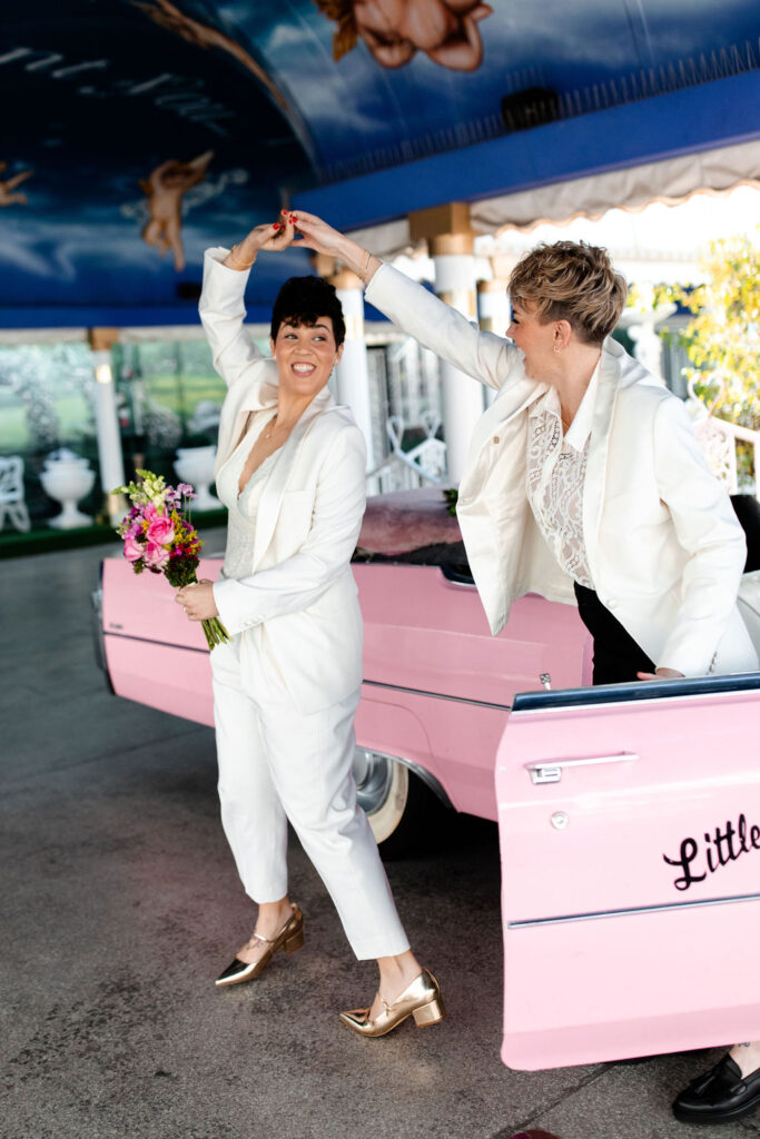 LGBTQ+ couple dancing during their Las Vegas wedding photos at Little White Wedding Chapel