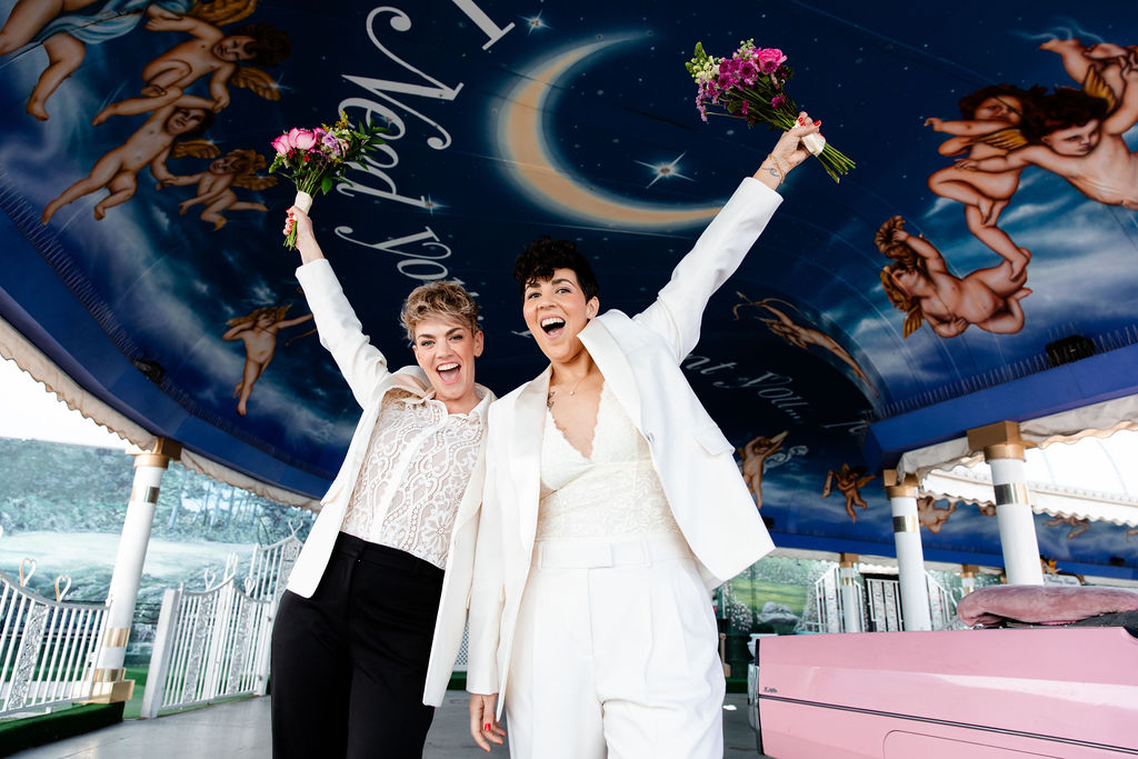 Couple with their hands up in the air after their Little White Chapel wedding