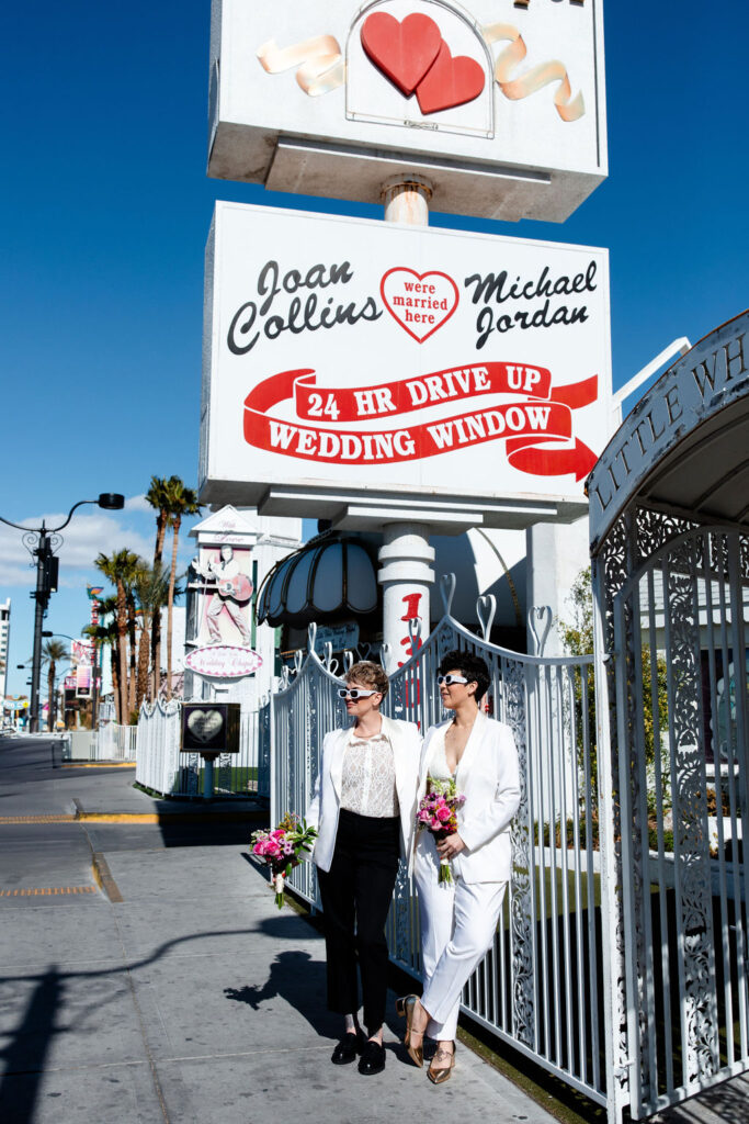 Couple posing outside of Little White Wedding Chapel in Las Vegas