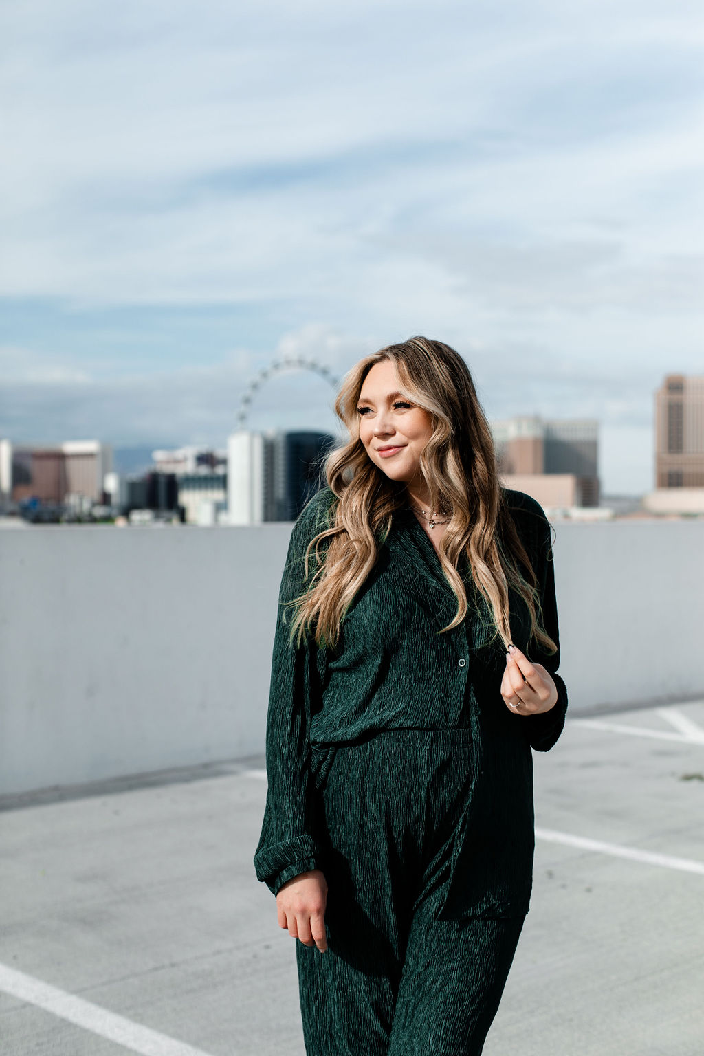 Ashlyn Savannah - a Las Vegas wedding and elopement photographer posing on a rooftop