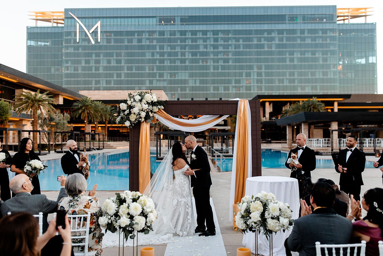 Bride and groom kissing during their outdoor Las Vegas wedding ceremony at The M Resort