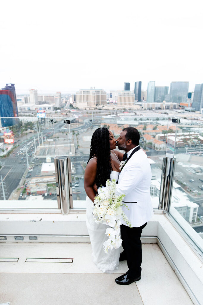 Bride and groom posing on a Las Vegas balcony