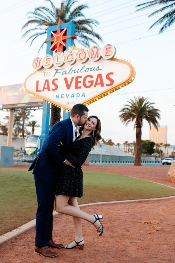 Couple posing in front of the the Welcome to Fabulous Las Vegas sign