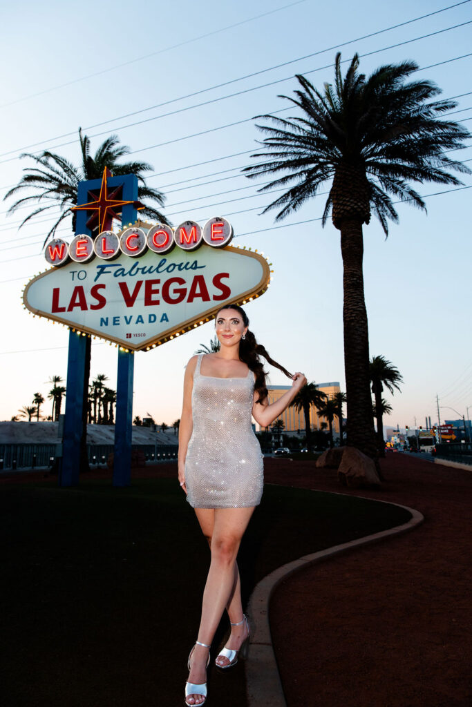 Woman posing in front of the Welcome to Fabulous Las Vegas sign for her bachelorette party photos