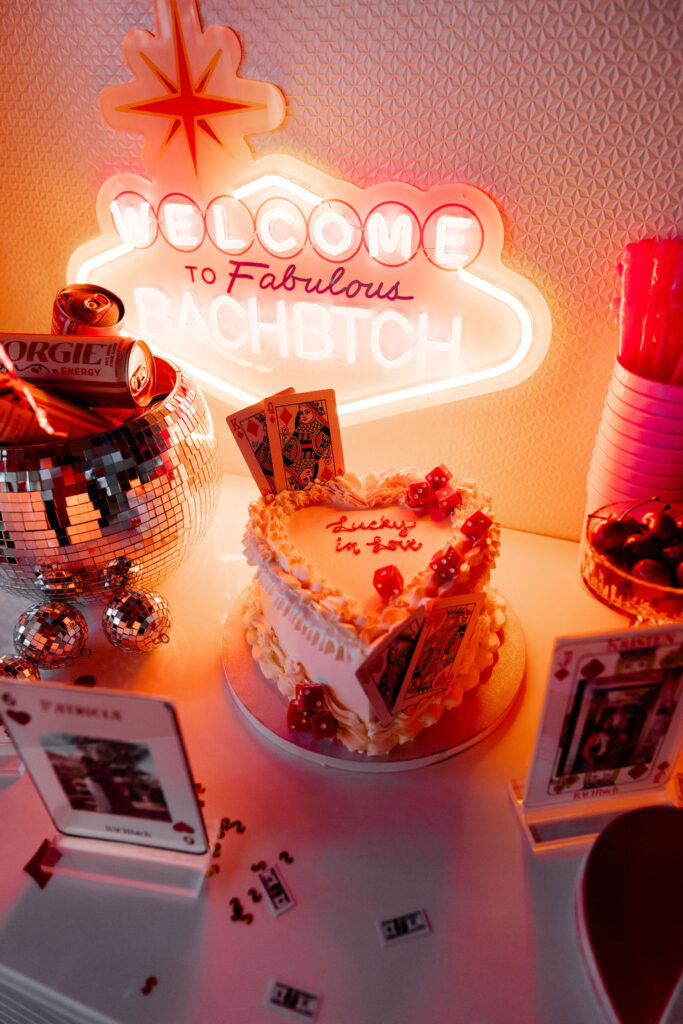 Lucky in Love themed bachelorette cake with playing cards, disco balls, and neon Vegas-inspired décor