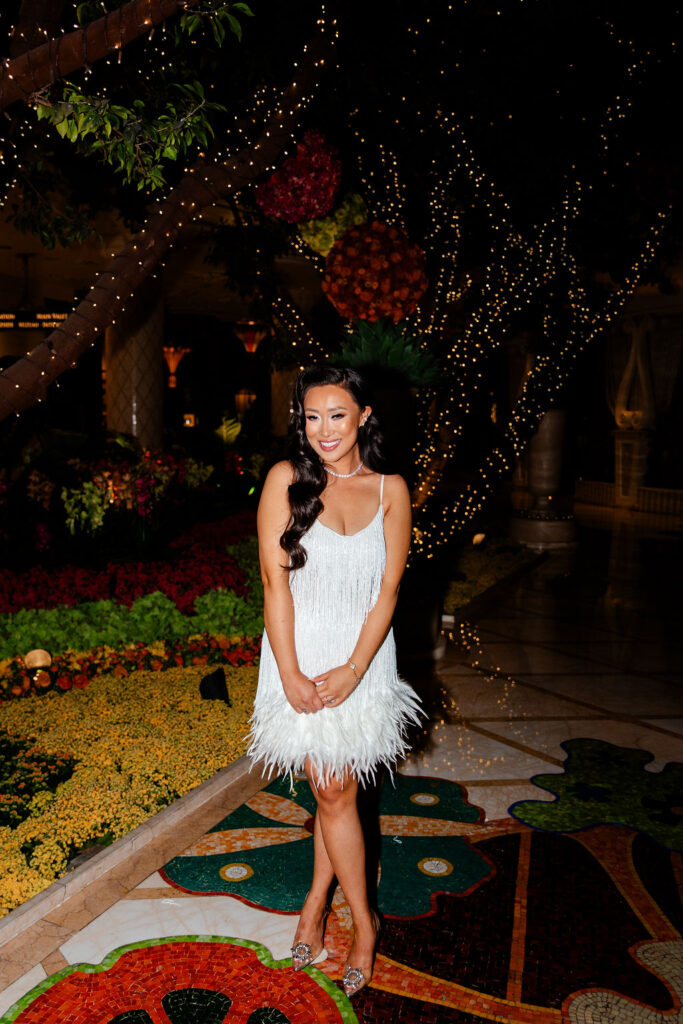 Bride wearing a short white fringed dress for her Gatsby Glam Las Vegas bachelorette party